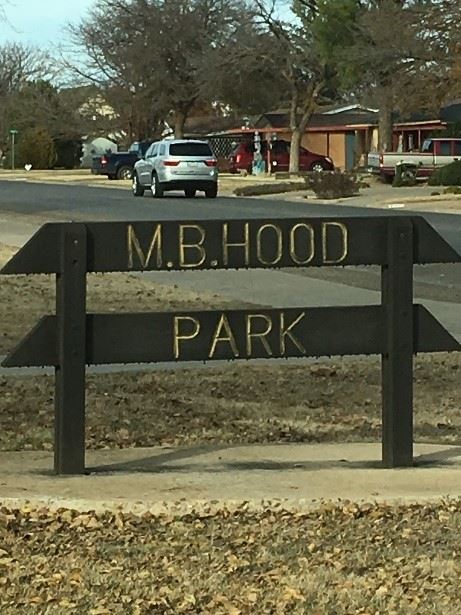 A wood sign that reads M.B. Hood Park